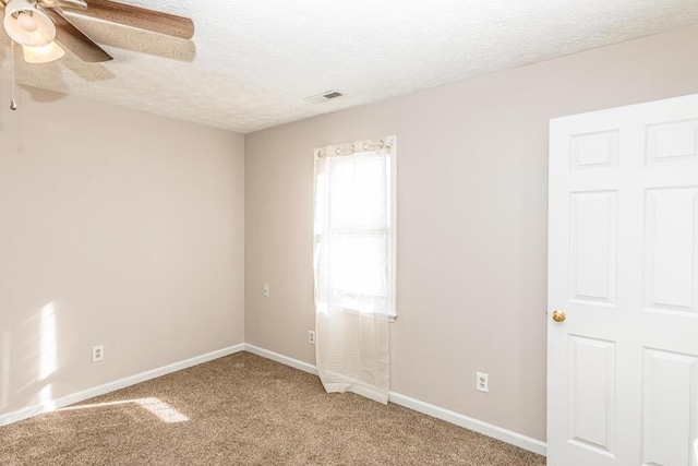 unfurnished room with a textured ceiling, carpet floors, and ceiling fan