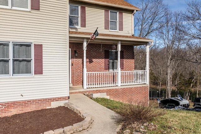 view of front of house featuring covered porch and a trampoline