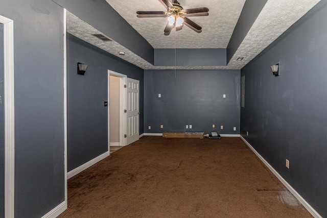 carpeted empty room with ceiling fan and a textured ceiling