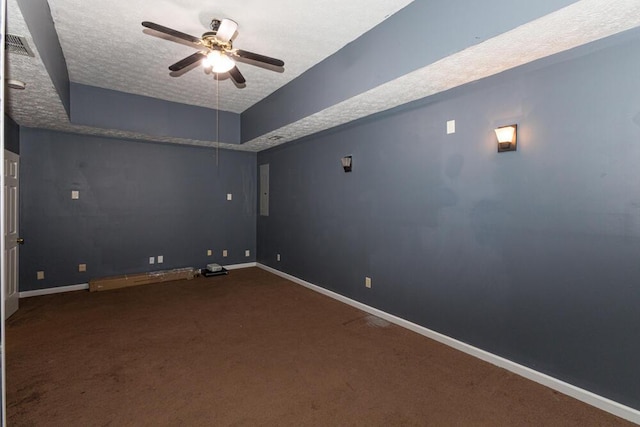 empty room with ceiling fan, carpet floors, and a textured ceiling