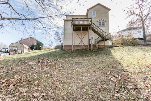 rear view of property featuring a yard and a deck