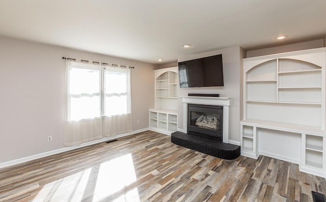 unfurnished living room featuring wood-type flooring