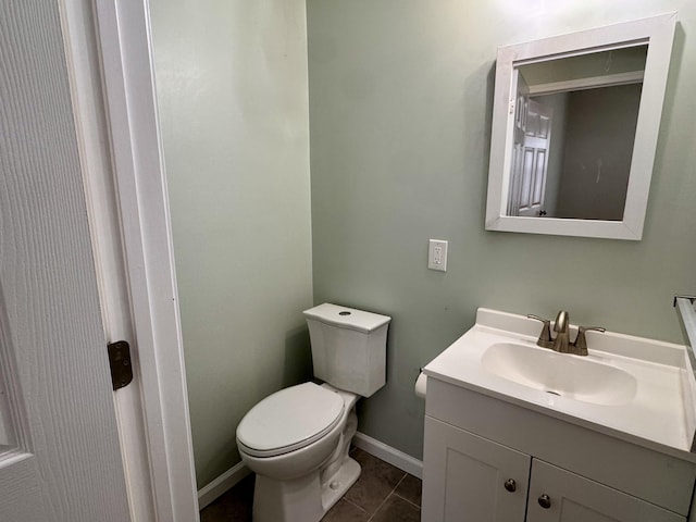 bathroom featuring tile patterned flooring, vanity, and toilet