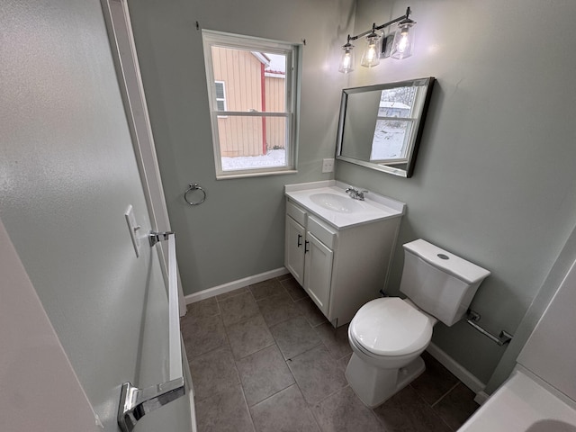 bathroom featuring tile patterned flooring, vanity, and toilet