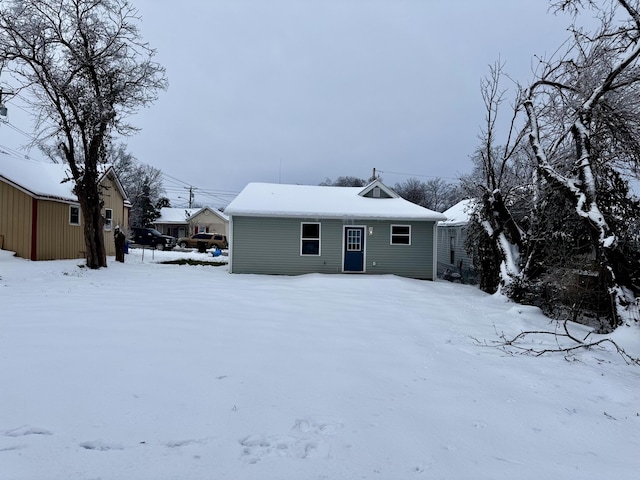 view of snow covered rear of property