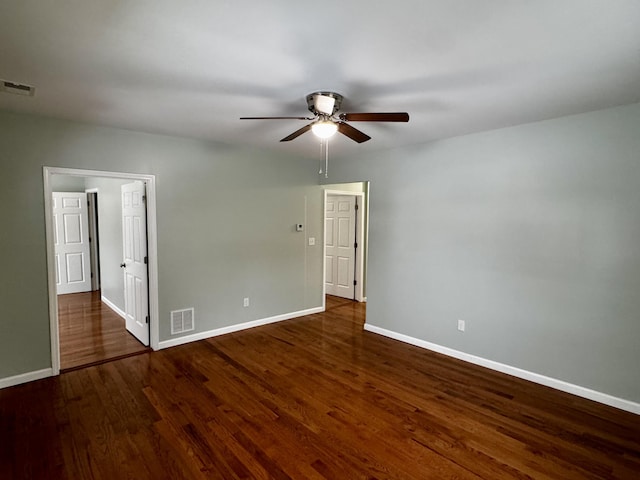 unfurnished room with ceiling fan and dark wood-type flooring