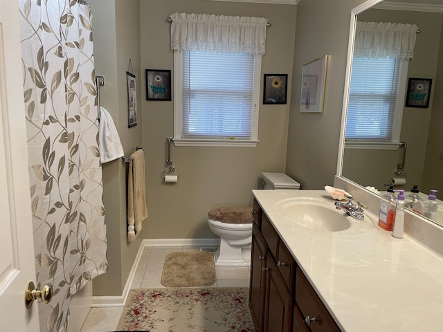 bathroom with toilet, vanity, and tile patterned floors