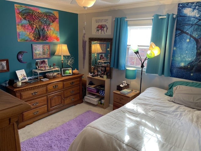 carpeted bedroom with ceiling fan and ornamental molding