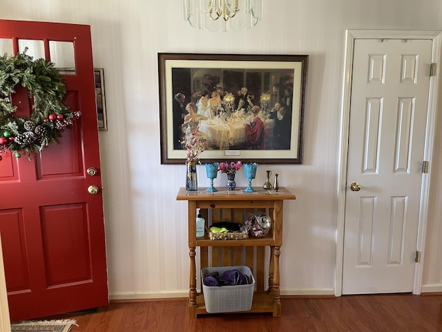 foyer with hardwood / wood-style flooring and an inviting chandelier