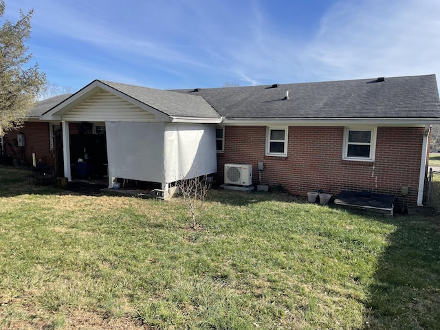 rear view of property featuring ac unit and a lawn