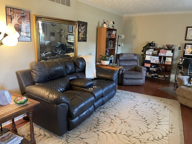 living room with a textured ceiling, hardwood / wood-style flooring, and ornamental molding