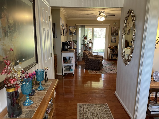 hallway with dark hardwood / wood-style floors and ornamental molding