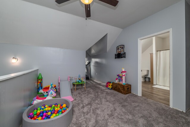 bedroom featuring lofted ceiling, a notable chandelier, and dark carpet