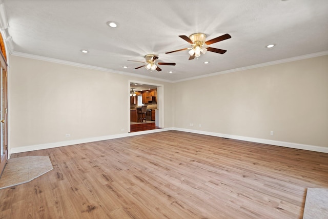 spare room featuring ceiling fan, light wood-type flooring, and ornamental molding