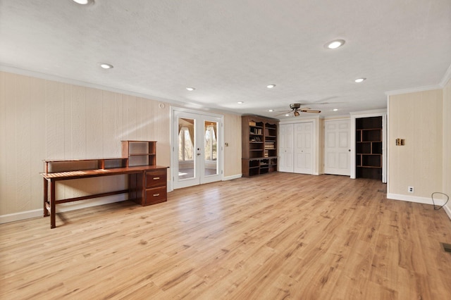 unfurnished living room featuring crown molding, french doors, ceiling fan, and light wood-type flooring