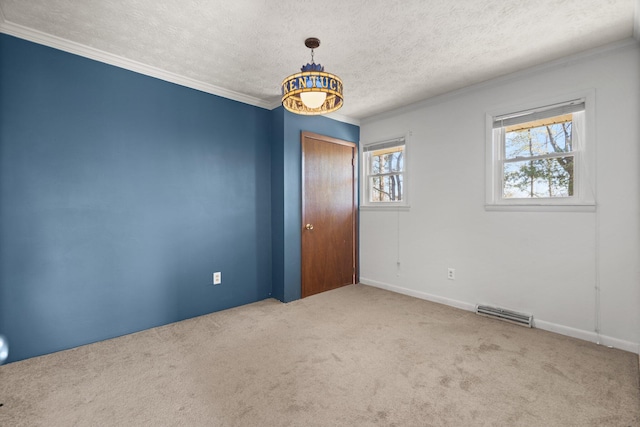 carpeted empty room featuring a textured ceiling and ornamental molding