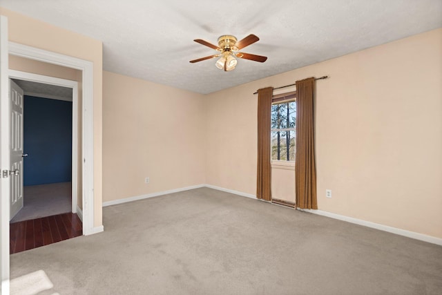 carpeted empty room with ceiling fan and a textured ceiling