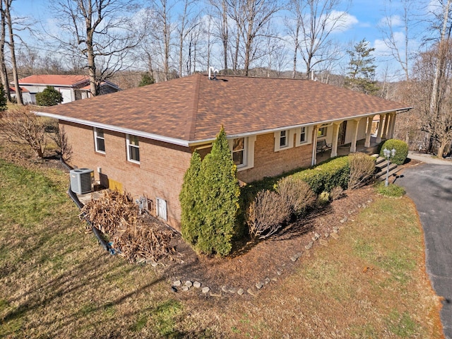 view of side of property featuring central AC unit and a porch