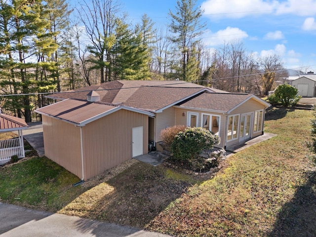 view of side of property with a lawn