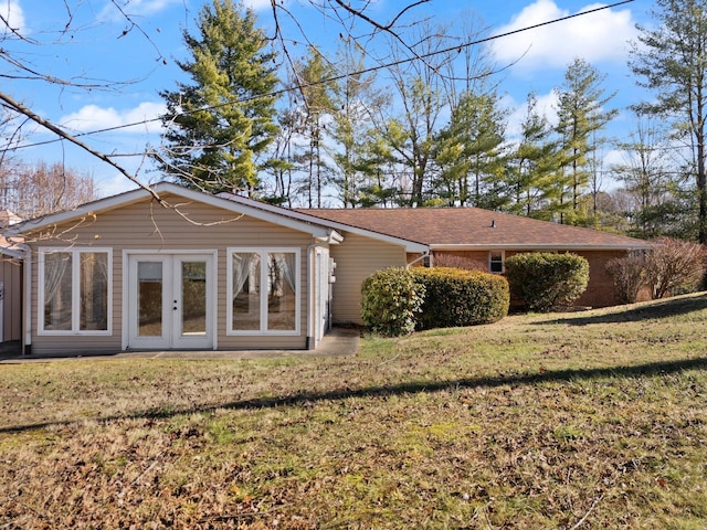 rear view of property with a yard and french doors