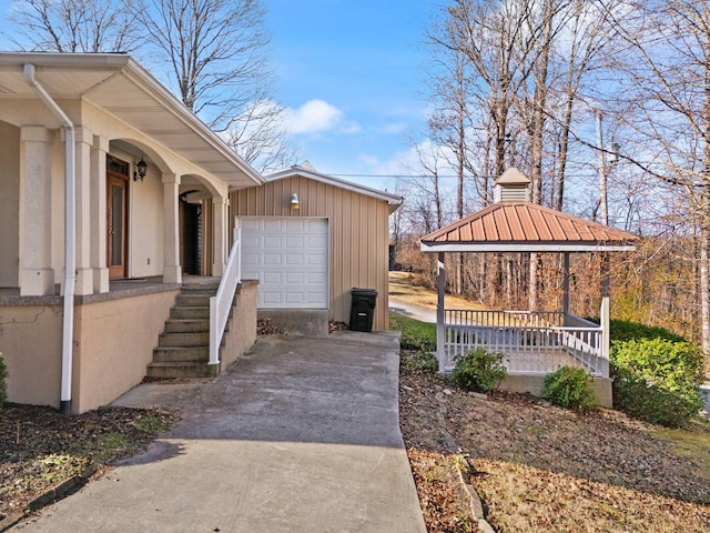 view of property exterior featuring a porch and a garage