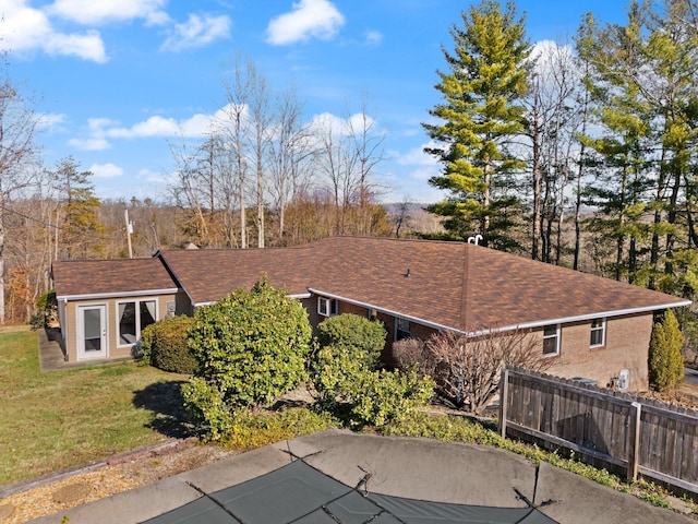 back of property featuring a yard