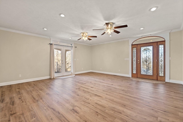 interior space featuring french doors, light wood-type flooring, ceiling fan, and ornamental molding