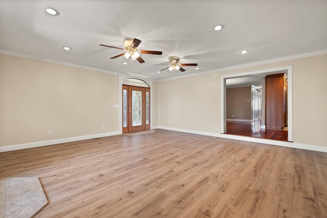 unfurnished room featuring ceiling fan, crown molding, and light hardwood / wood-style flooring