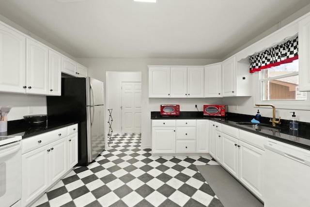 kitchen with white cabinetry, white appliances, and sink