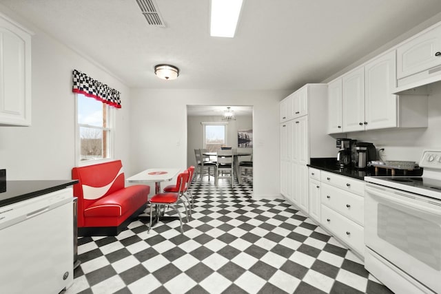 kitchen featuring white cabinets and white appliances