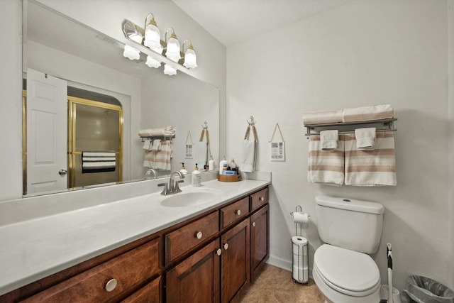 bathroom featuring walk in shower, tile patterned floors, vanity, and toilet