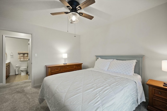 carpeted bedroom featuring ceiling fan and connected bathroom