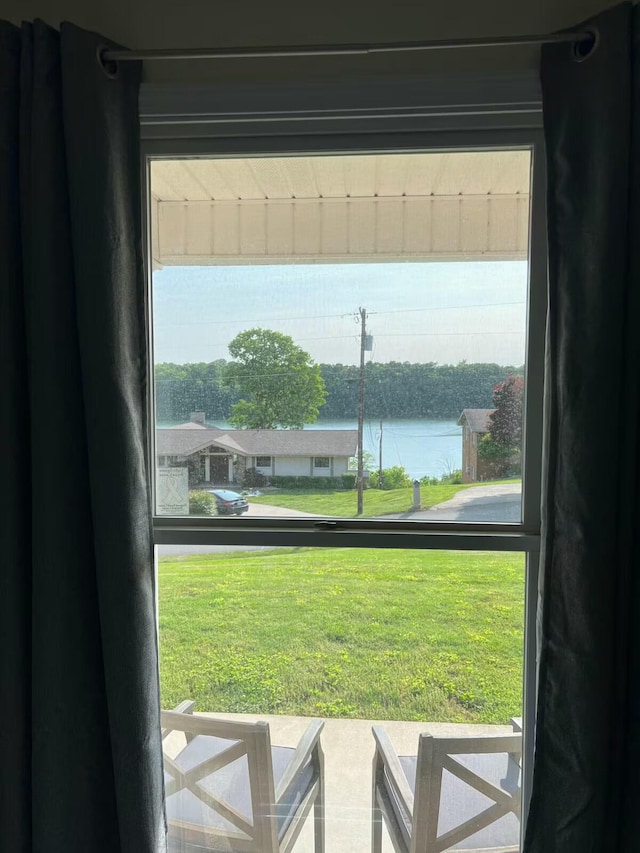 doorway to outside with a water view and plenty of natural light