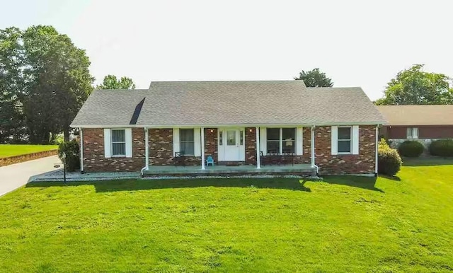 single story home with a front lawn and covered porch