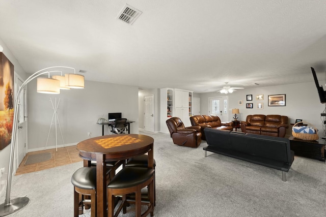 carpeted living room with ceiling fan