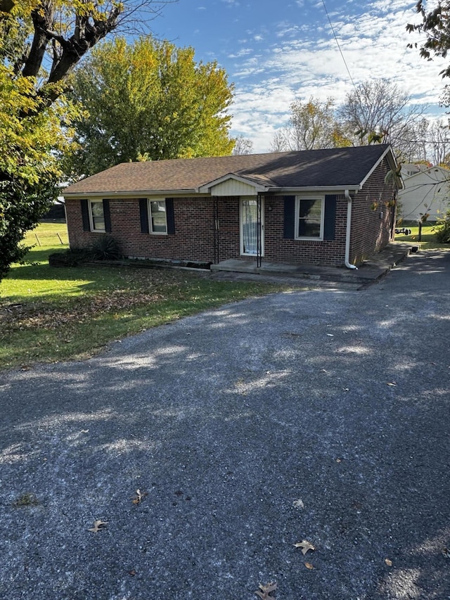 single story home featuring a front lawn