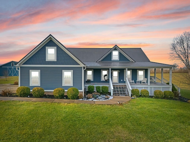 view of front of property featuring a yard and a porch