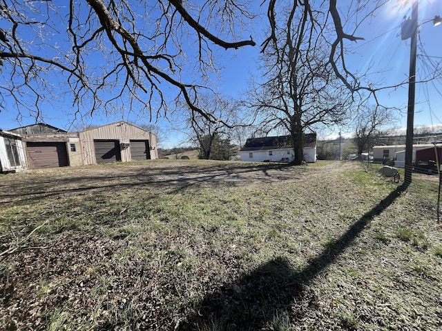 view of yard with a garage and an outdoor structure