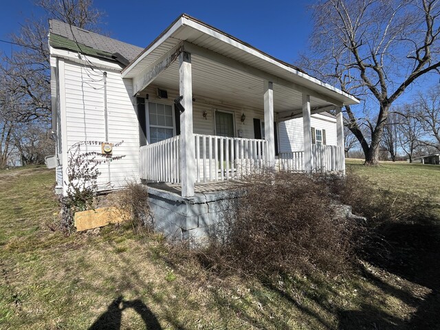 view of side of property with a yard