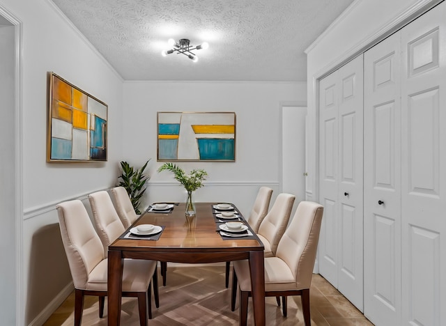 dining space featuring a textured ceiling and crown molding