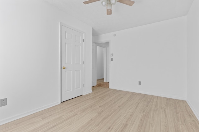 empty room with light hardwood / wood-style floors and ceiling fan