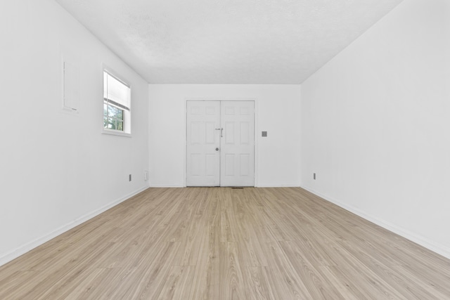 spare room featuring light hardwood / wood-style flooring