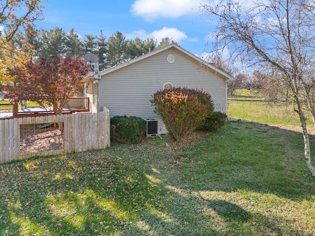 view of home's exterior with a lawn and central air condition unit