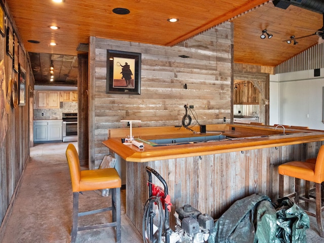 bar featuring wood ceiling, wooden walls, and range