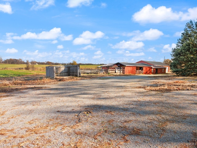 view of front of house featuring a rural view and an outdoor structure