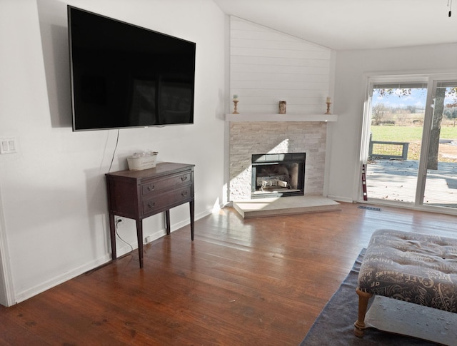 living room featuring dark hardwood / wood-style flooring and a fireplace