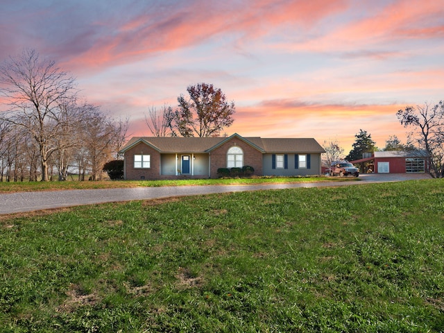 ranch-style home with a lawn