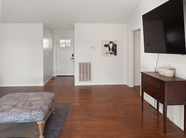 entrance foyer with lofted ceiling and dark hardwood / wood-style flooring