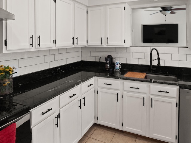 kitchen featuring light tile patterned floors, white cabinets, tasteful backsplash, and range hood