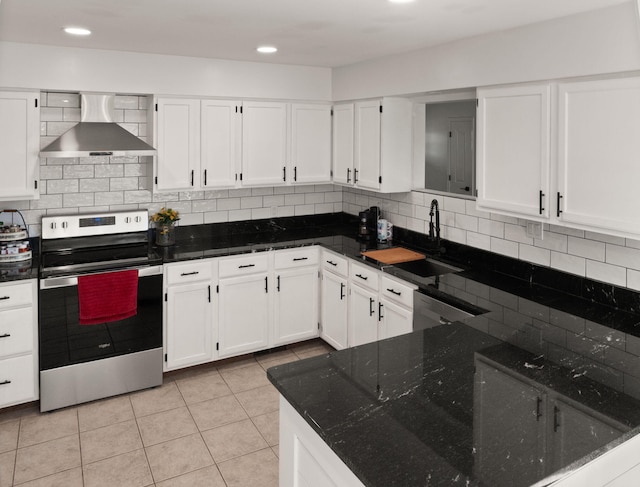 kitchen featuring white cabinetry, sink, wall chimney range hood, and appliances with stainless steel finishes